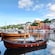 A mix of wooden and power boats docked in the harbor of Haugesund, Norway, alongside picturesque buildings